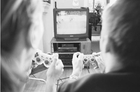 Sixty percent of the audience for interactive games, like this video hockey game, are children. The electronic gaming industry has voluntarily begun to rate its products, although rating labels and advisories are widely ignored by distributors and retailers. CORBIS